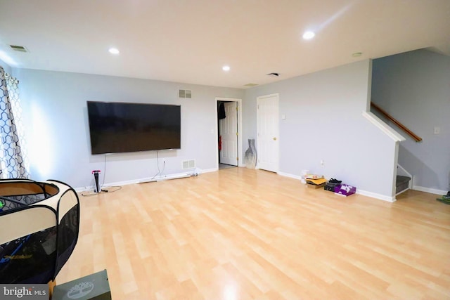 living room with visible vents, recessed lighting, stairs, and wood finished floors