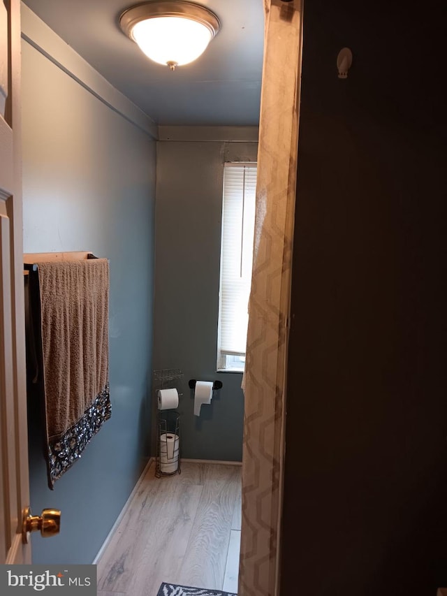 bathroom with hardwood / wood-style flooring