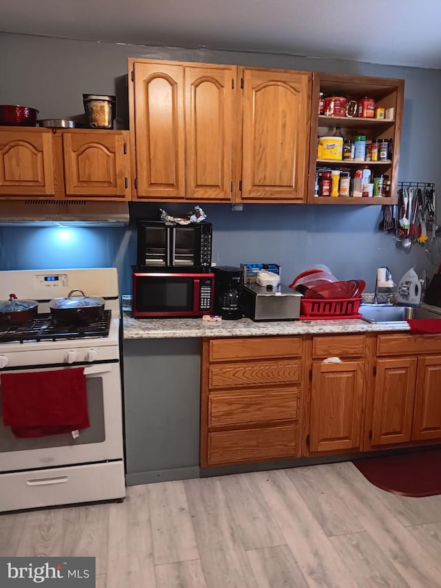 kitchen with gas range gas stove and light hardwood / wood-style flooring