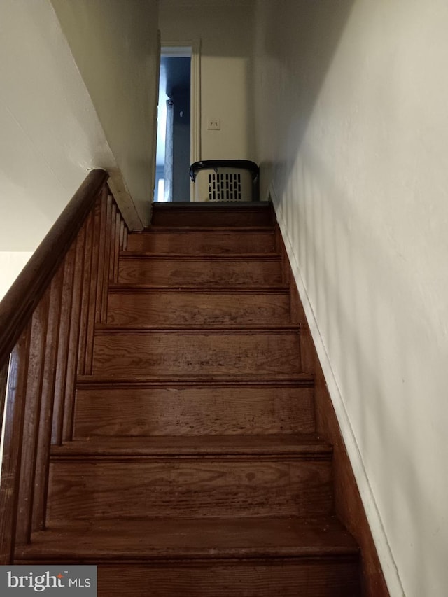 stairway featuring wood-type flooring