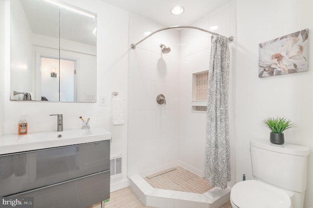 bathroom with oversized vanity, toilet, and walk in shower