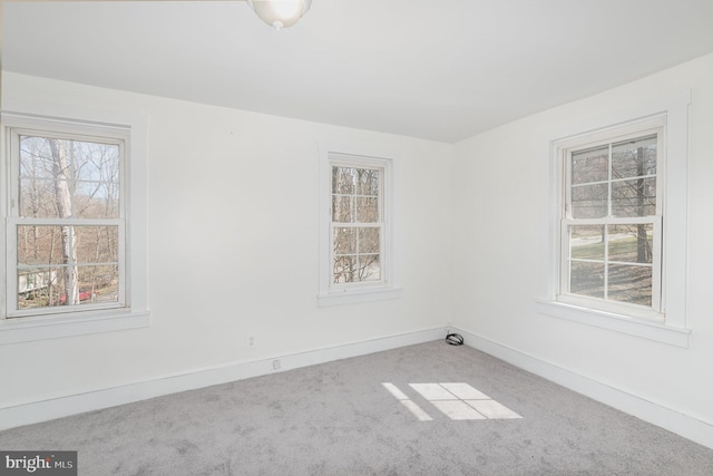 spare room featuring light colored carpet