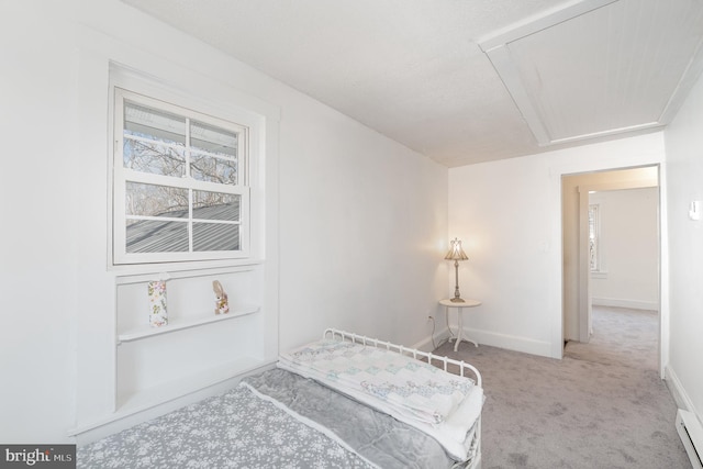 carpeted bedroom with a baseboard heating unit