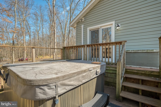 wooden terrace featuring a hot tub