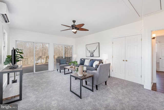 carpeted living room featuring a wall mounted air conditioner and ceiling fan