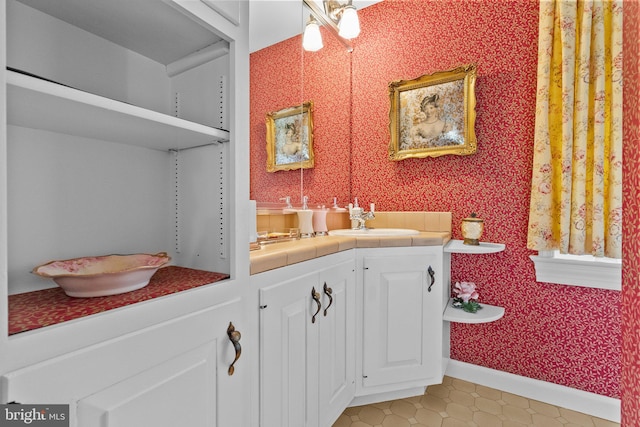 bathroom featuring tile flooring and vanity with extensive cabinet space