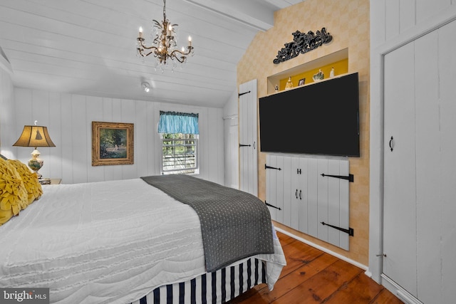 bedroom with dark hardwood / wood-style flooring, lofted ceiling with beams, a closet, and an inviting chandelier