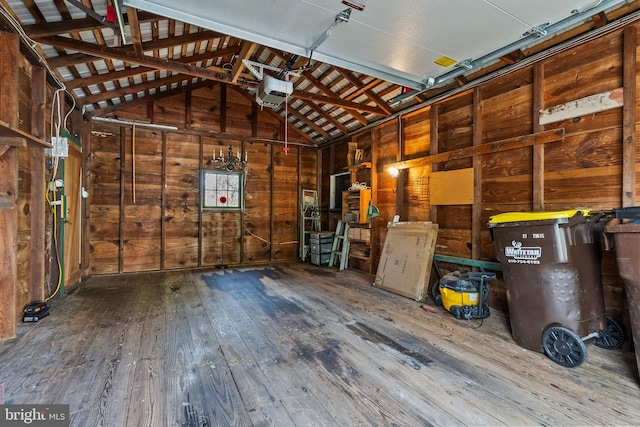 garage with wooden walls and a garage door opener