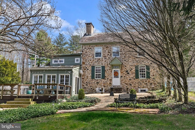 rear view of house featuring a wooden deck