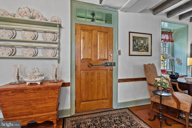 entrance foyer with dark hardwood / wood-style floors and beamed ceiling