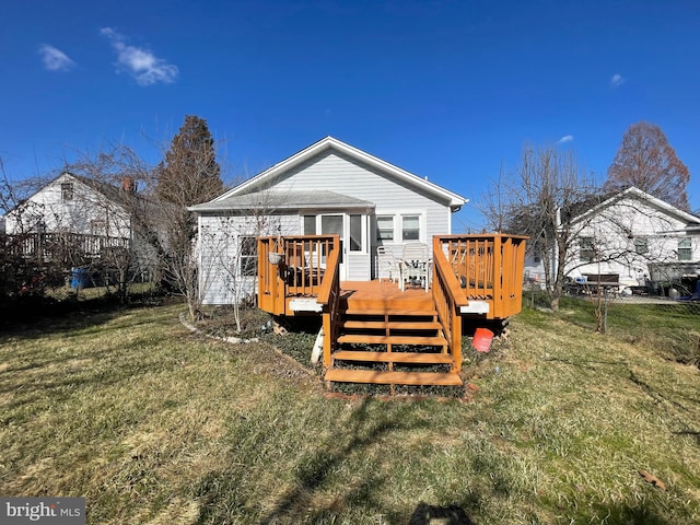 back of property with a yard and a wooden deck