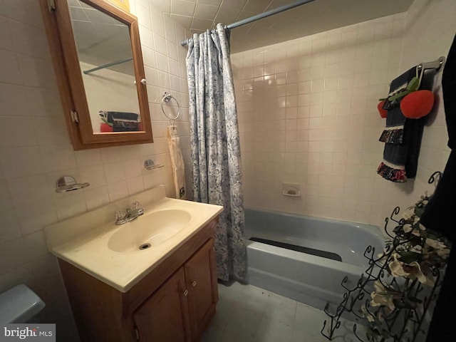 full bathroom with vanity, tile walls, shower / tub combo, and toilet