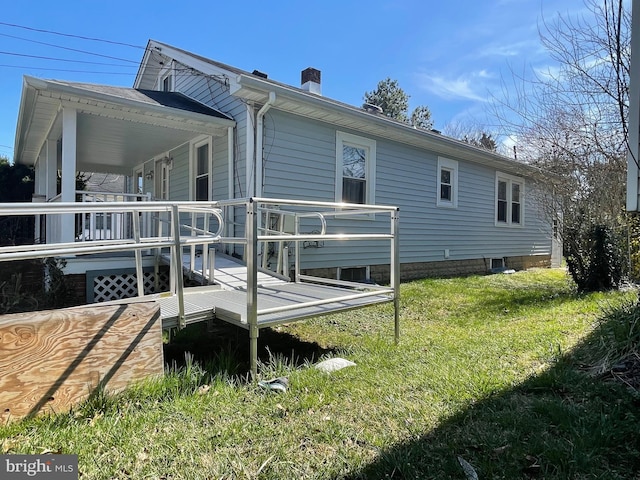 view of side of home with a lawn