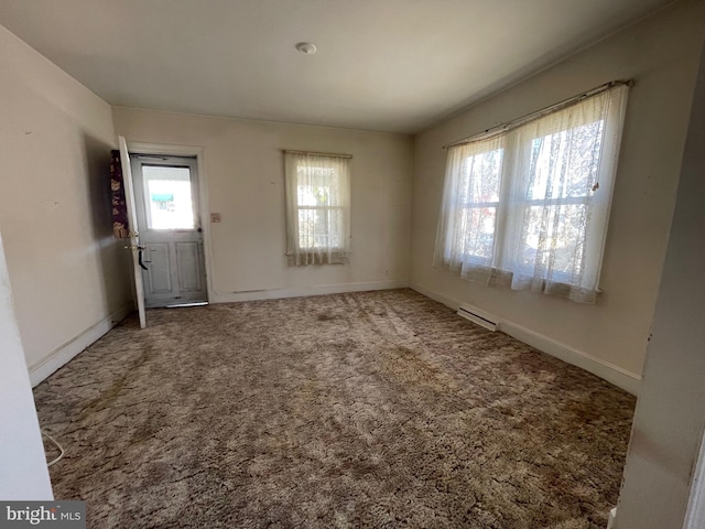 carpeted foyer featuring baseboard heating