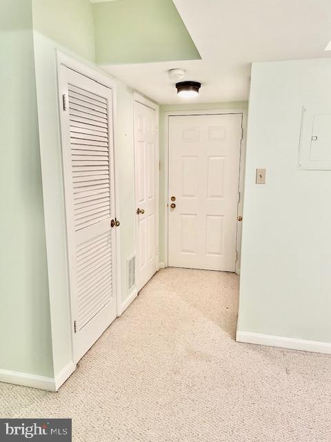 corridor with light colored carpet