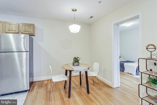 dining area featuring light wood-type flooring