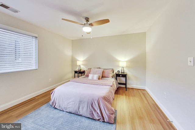 bedroom with light hardwood / wood-style flooring and ceiling fan