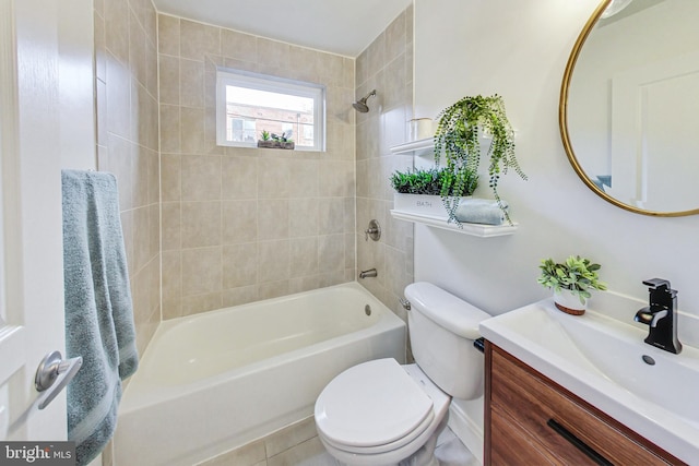 full bathroom featuring tile patterned floors, vanity, toilet, and tiled shower / bath combo