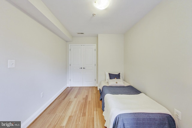 bedroom featuring hardwood / wood-style floors and a closet