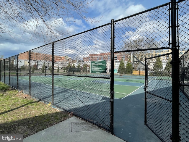 view of tennis court featuring basketball hoop