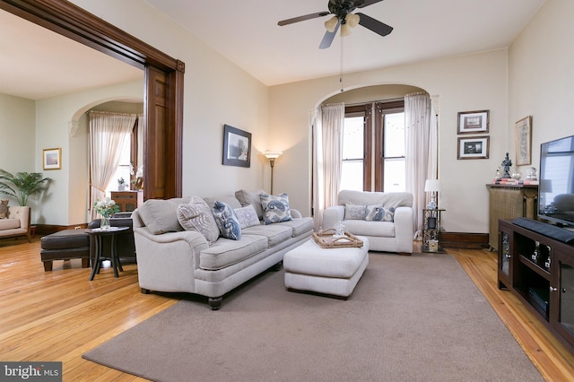 living room featuring ceiling fan and hardwood / wood-style floors