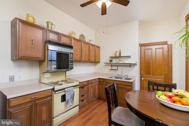 kitchen featuring sink, ceiling fan, electric range, and light hardwood / wood-style floors