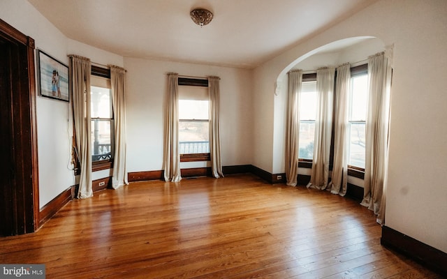 empty room with hardwood / wood-style flooring