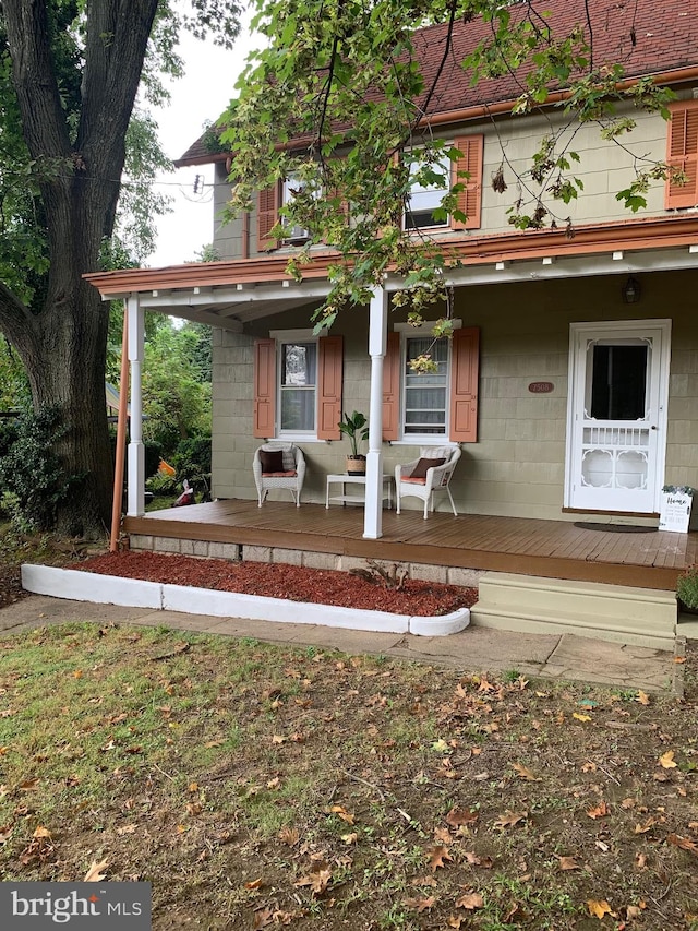 view of front facade featuring covered porch and concrete block siding