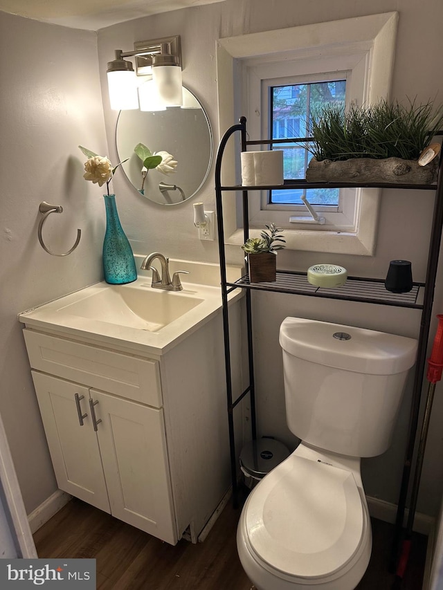 bathroom featuring hardwood / wood-style flooring, vanity, and toilet