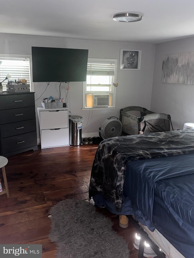 bedroom featuring cooling unit and dark hardwood / wood-style floors