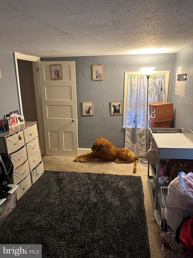 carpeted bedroom featuring a textured ceiling