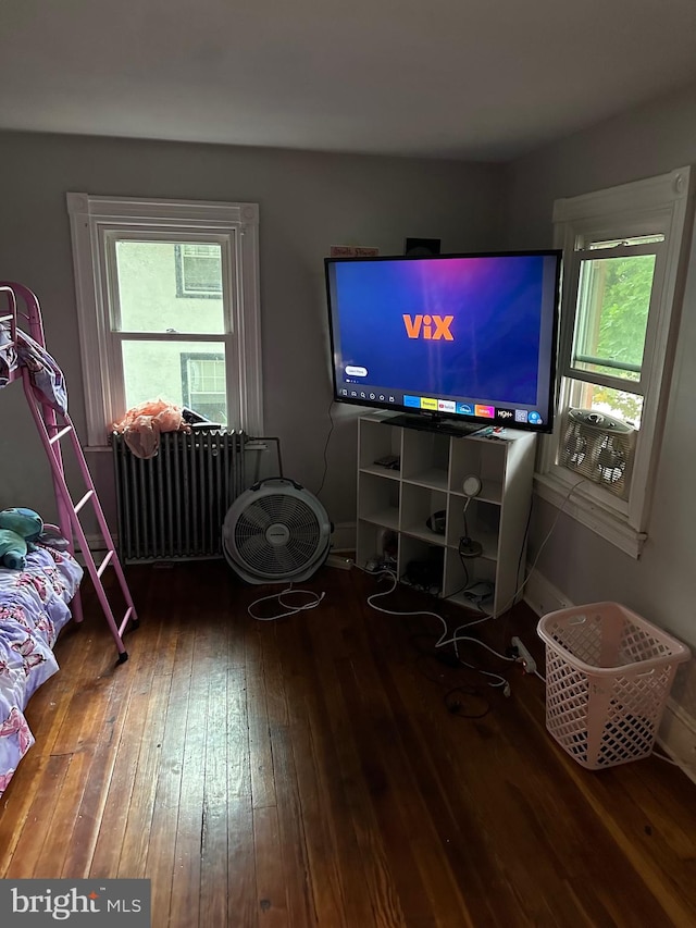 living room with radiator heating unit and hardwood / wood-style flooring