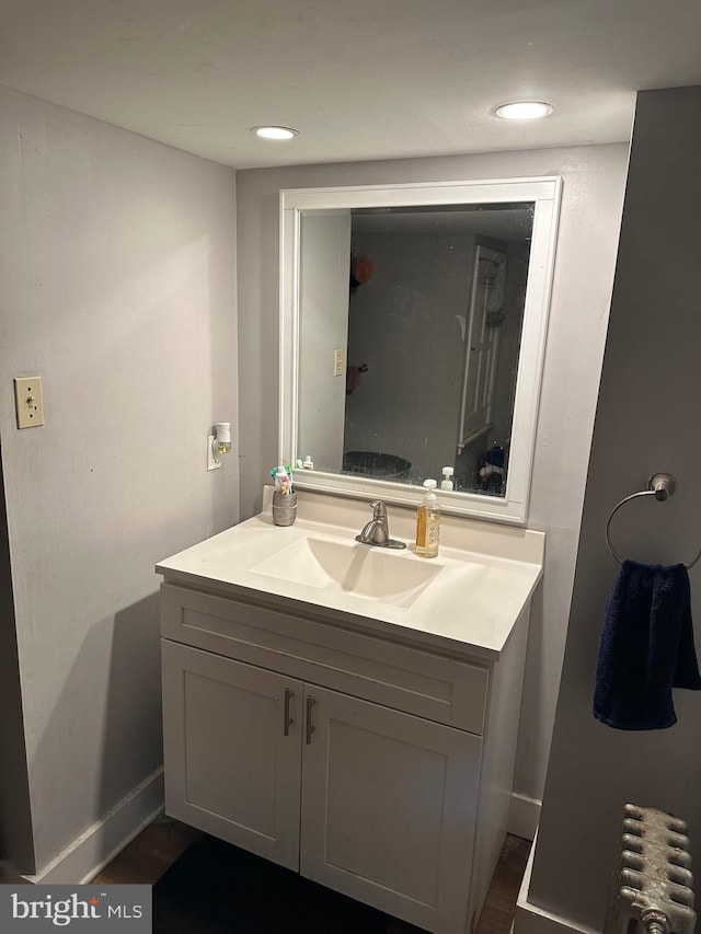 bathroom with vanity and radiator