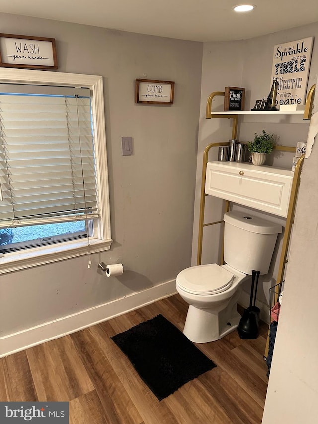 bathroom with hardwood / wood-style flooring and toilet