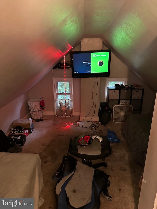 bonus room with lofted ceiling and carpet flooring