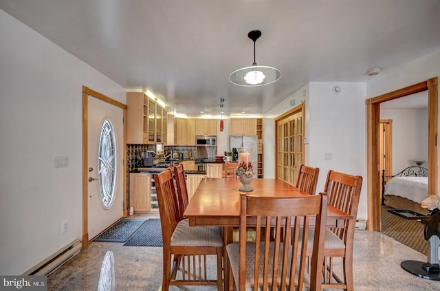 dining area featuring a baseboard heating unit