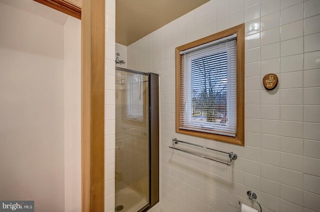 bathroom with tile walls and an enclosed shower