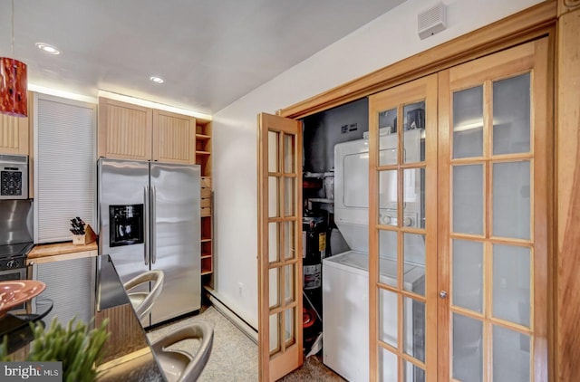 office area with french doors and stacked washer / drying machine