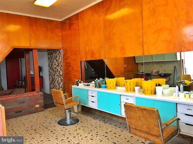 kitchen featuring ornamental molding and light tile floors