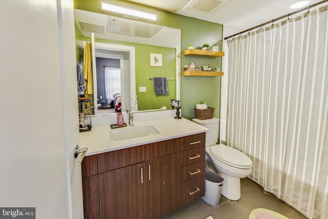 bathroom featuring toilet, tile floors, and vanity