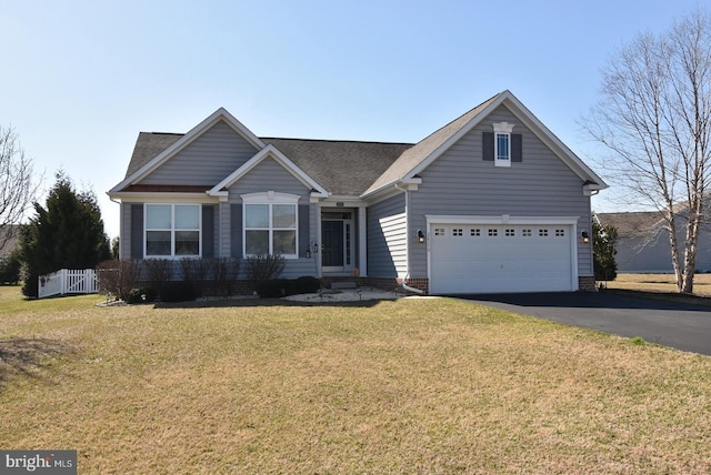 view of front of home featuring a front yard and a garage