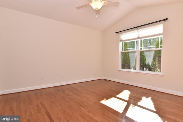 unfurnished room with ceiling fan, hardwood / wood-style floors, and vaulted ceiling