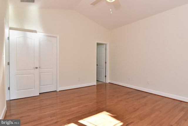 unfurnished bedroom with ceiling fan, light wood-type flooring, and vaulted ceiling