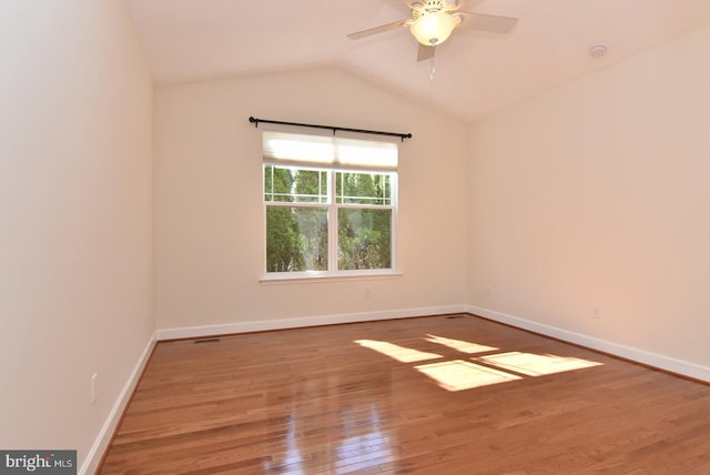 spare room with ceiling fan, lofted ceiling, and dark hardwood / wood-style floors