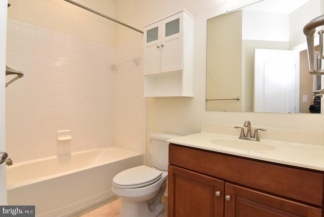 full bathroom featuring tile floors, vanity, toilet, and tiled shower / bath