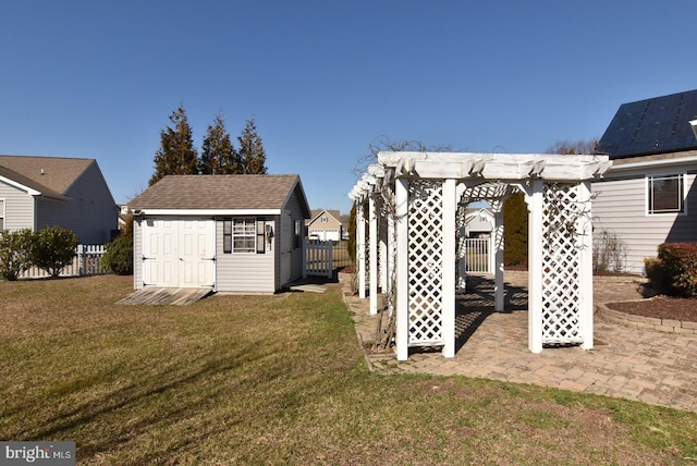 view of yard with a storage shed and a pergola