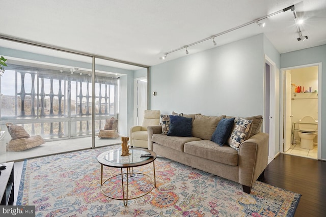 living room with rail lighting and tile floors