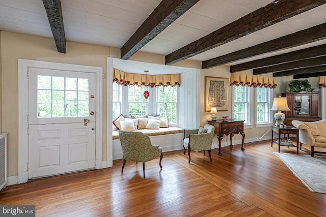 entrance foyer featuring plenty of natural light, hardwood / wood-style flooring, and beam ceiling