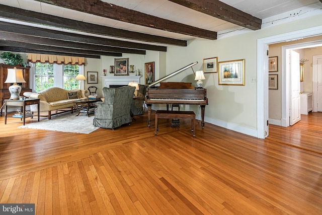 living room featuring beamed ceiling and hardwood / wood-style flooring