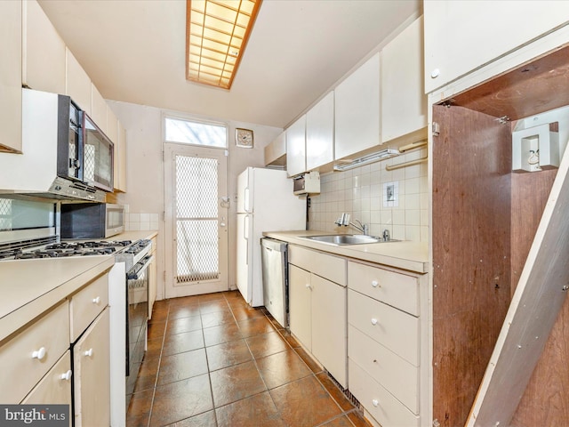 kitchen with sink, white cabinets, and appliances with stainless steel finishes